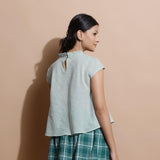 Back View of a Model wearing Light Green Cotton Muslin Flared Top