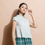 Right View of a Model wearing Light Green Cotton Muslin Flared Top