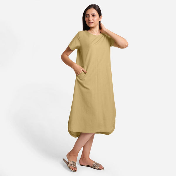 Right View of a Model wearing Light Khaki Cotton Welt Pocket Shift Dress