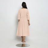 Back View of a Model wearing Vegetable-Dyed Light Pink 100% Cotton Button-Down Dress