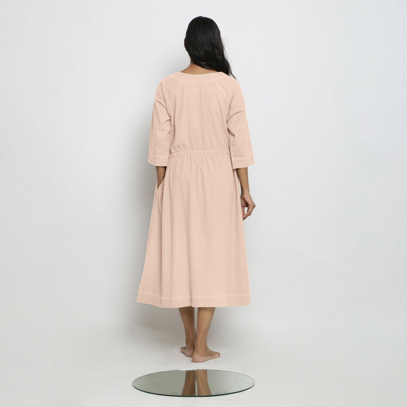 Back View of a Model wearing Vegetable-Dyed Light Pink 100% Cotton Button-Down Dress