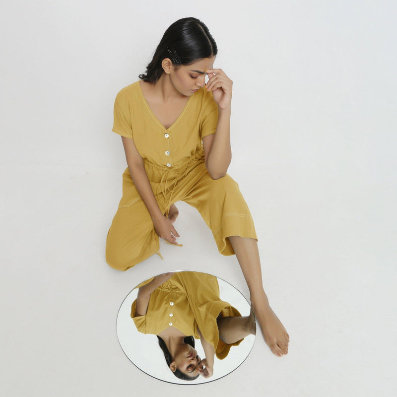 Front View of a Model wearing Light Yellow Vegetable Dyed Button-Down Jumpsuit