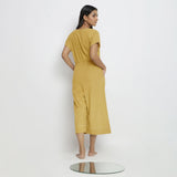 Back View of a Model wearing Light Yellow Vegetable Dyed Button-Down Jumpsuit