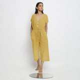 Front View of a Model wearing Light Yellow Vegetable Dyed Button-Down Jumpsuit