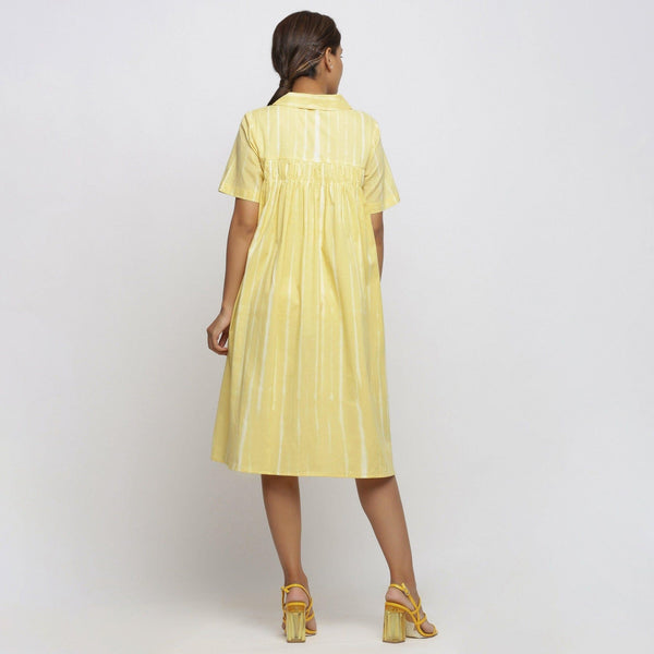 Back View of a Model wearing Light Yellow Tie And Dye High Low Dress