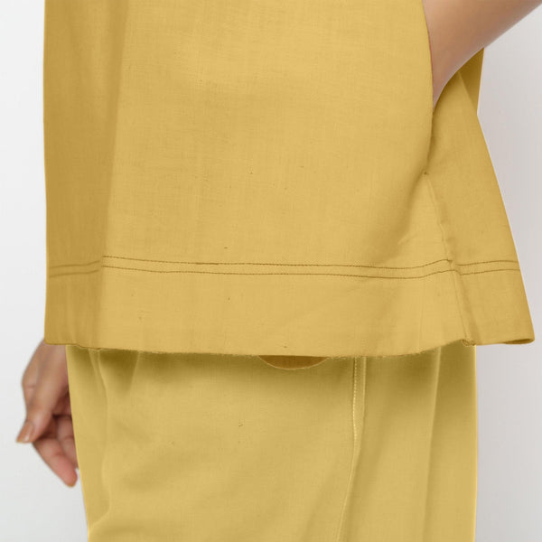 Close View of a Model wearing Vegetable Dyed yellow Boat Neck A-Line Top