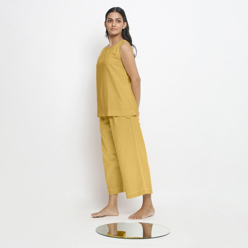 Left View of a Model wearing Vegetable Dyed yellow Boat Neck A-Line Top