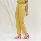 Left View of a Model wearing Mustard Handspun Cotton High-Rise Elasticated Paperbag Pant