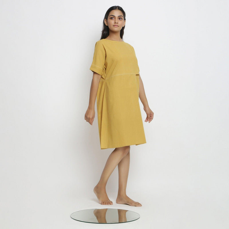 Right View of a Model wearing Lemon Yellow Vegetable Dyed Handspun Cotton Knee Length Yoked Dress