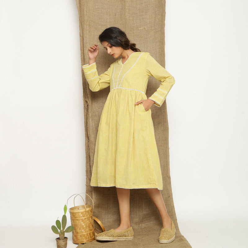 Left View of a Model wearing Handspun Light Yellow Gathered Dress