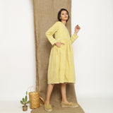 Right View of a Model wearing Handspun Light Yellow Gathered Dress