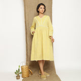 Front View of a Model wearing Handspun Light Yellow Gathered Dress