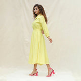 Left View of a Model wearing Light Yellow Handspun Cotton Yoked Button-Down Midi Dress