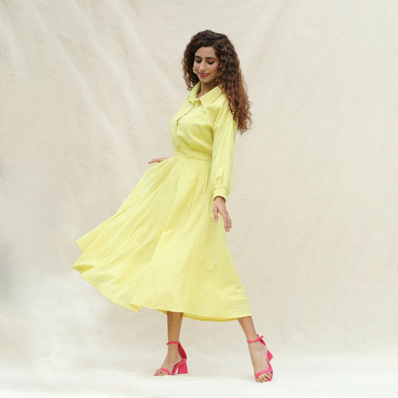 Left View of a Model wearing Light Yellow Handspun Cotton Yoked Button-Down Midi Dress