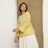 Left View of a Model wearing Handspun Light Yellow Poet Sleeve Top