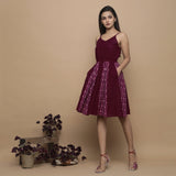 Left View of a Model wearing Maroon Ikat Handwoven Cotton Paneled Knee Length Dress