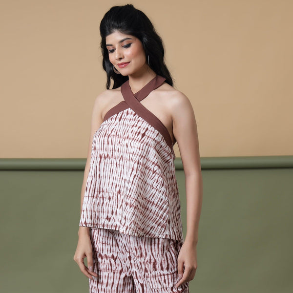 Left View of a Model wearing Maroon Shibori Tie-Dye Cotton Halter Neck Flared Top