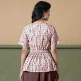 Back View of a Model wearing Shibori Button-Down Maroon Peplum Top