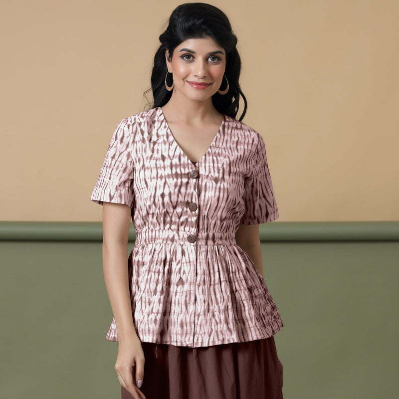 Front View of a Model wearing Shibori Button-Down Maroon Peplum Top