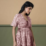 Right View of a Model wearing Maroon Shibori Drop Shoulder Dress