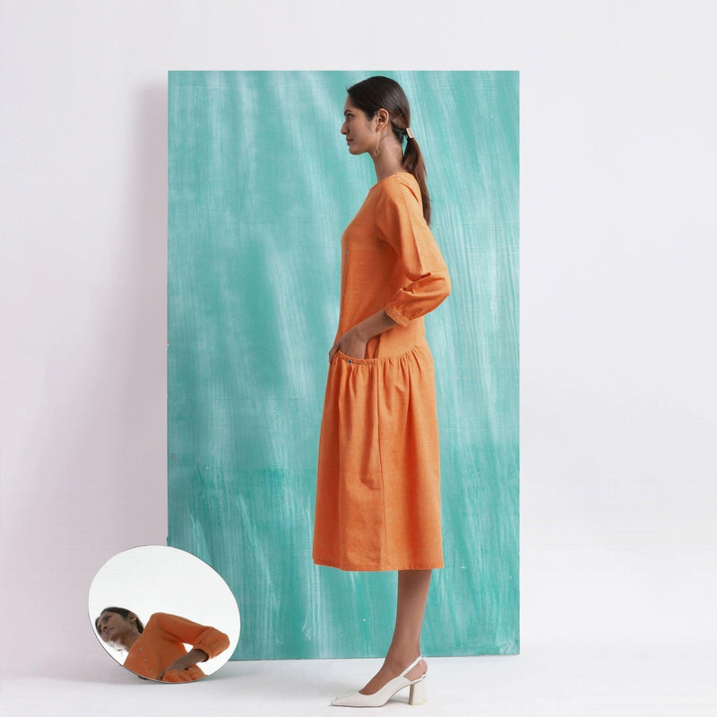 Left View of a Model wearing Melon Orange Comfort Fit Mirror Work Dress