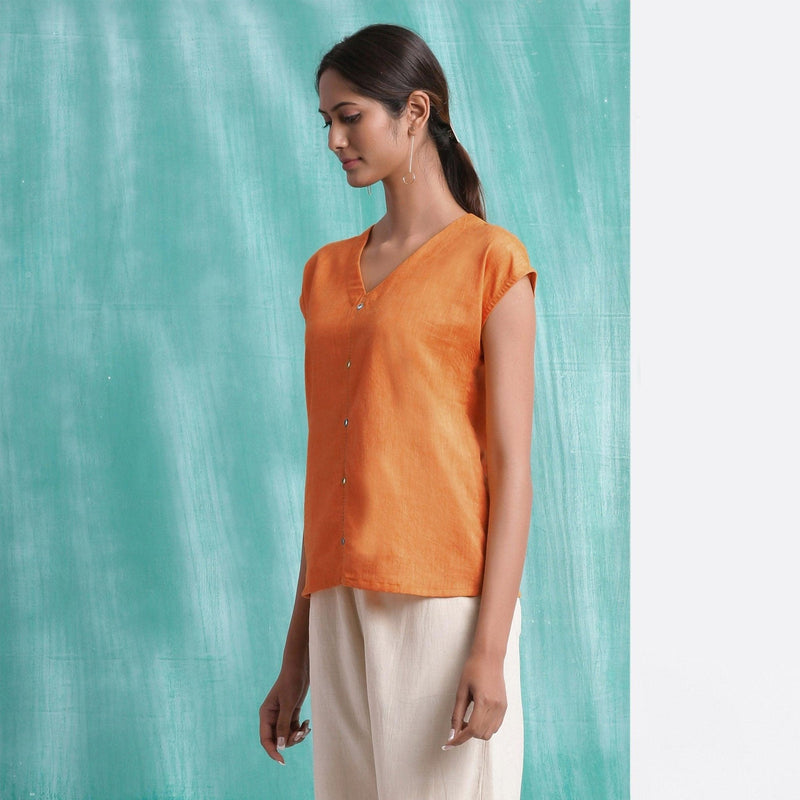 Left View of a Model wearing Melon Orange Mirror Work Drop Shoulder Top