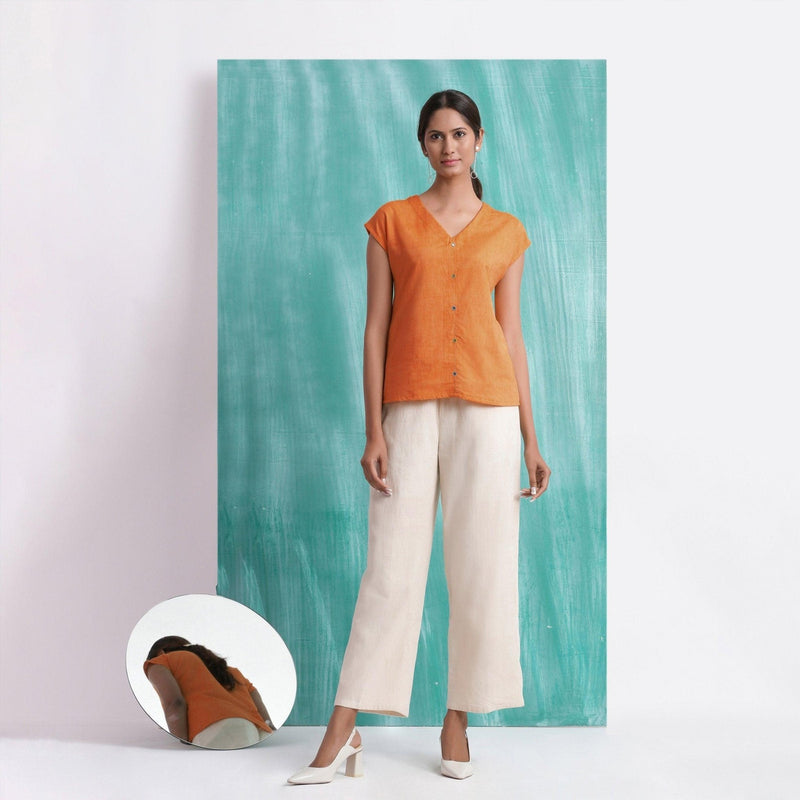 Front View of a Model wearing Melon Orange Mirror Work Drop Shoulder Top