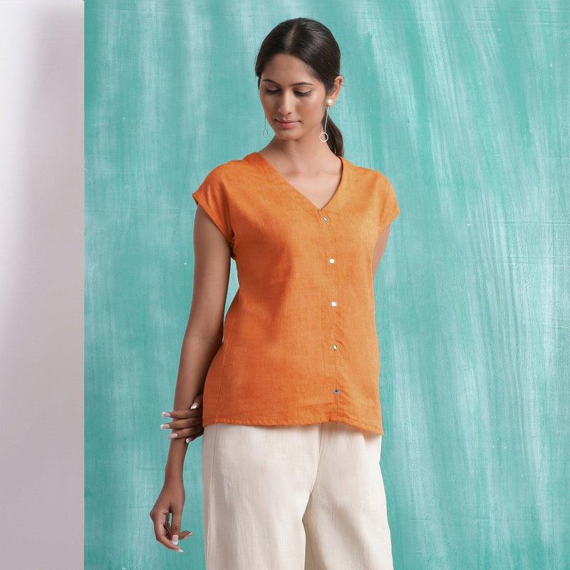 Front View of a Model wearing Melon Orange Mirror Work Drop Shoulder Top