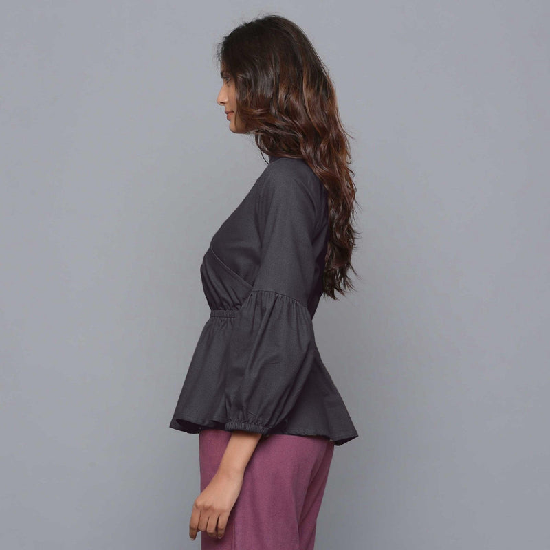 Left View of a Model wearing Moonlight Black V-Neck Flannel Peplum Top