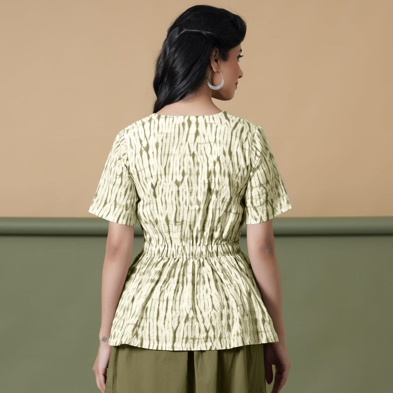 Back View of a Model wearing Shibori Button-Down Green Peplum Top