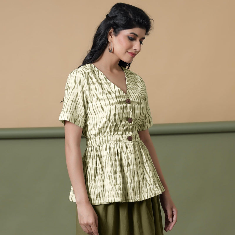 Right View of a Model wearing Shibori Button-Down Green Peplum Top