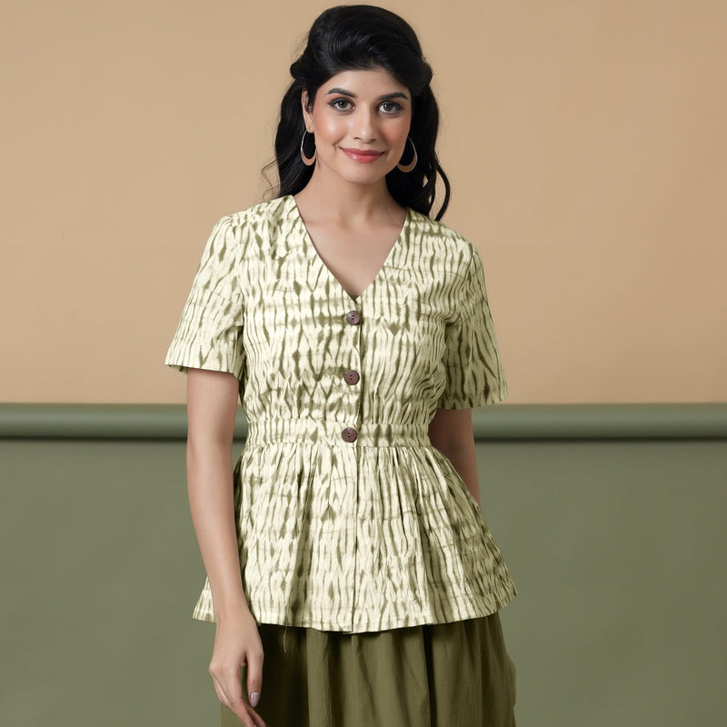 Front View of a Model wearing Shibori Button-Down Green Peplum Top