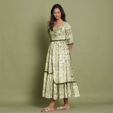 Left View of a Model wearing Olive Green Shibori Asymmetrical Tier Maxi Dress