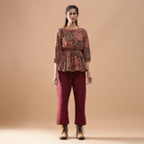 Front View of a Model wearing Muddy Red Kalamkari Floral Peplum Top