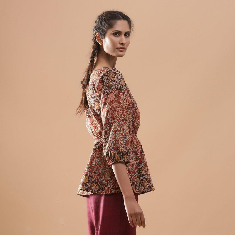 Right View of a Model wearing Muddy Red Kalamkari Floral Peplum Top