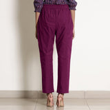 Back View of a Model wearing Warm Mulberry Frilled Waist Tapered Cotton Pant