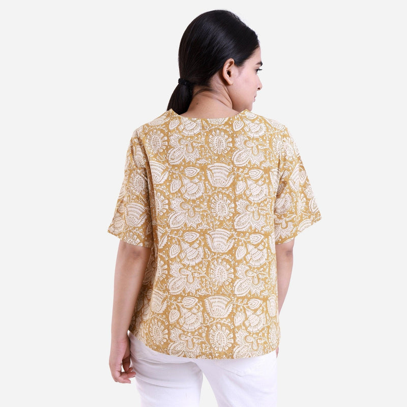 Back View of a Model wearing Mustard Bagru Printed Flared Top