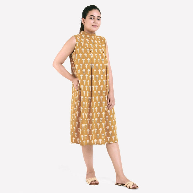 Right View of a Model wearing Mustard Bagru Block Print Pleated Cotton Midi Dress