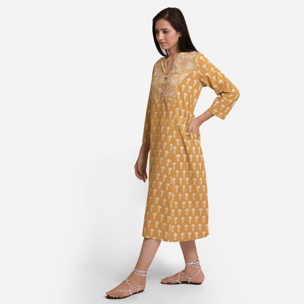 Left View of a Model wearing Mustard Block Print Princess Line Midi Cotton Dress