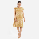 Front View of a Model wearing Mustard Block Printed Cotton Knee Length Yoke Dress