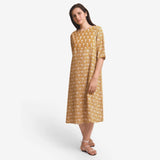 Front View of a Model wearing Mustard Block Printed Cotton Midi Yoke Dress