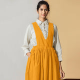 Front View of a Model wearing Mustard Cotton Flax Pinafore Midi Wrap Dress