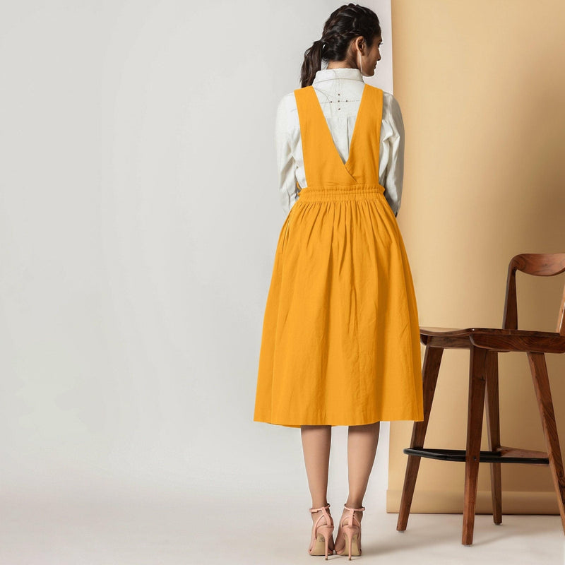 Back View of a Model wearing Mustard Cotton Flax Pinafore Midi Wrap Dress