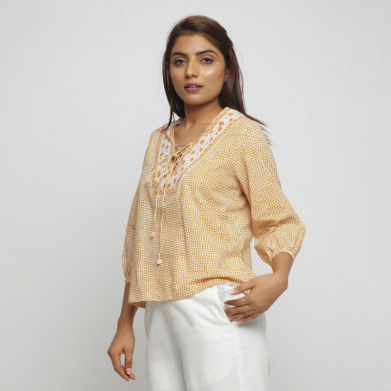 Left View of a Model wearing Mustard Hand Block Printed Straight Top