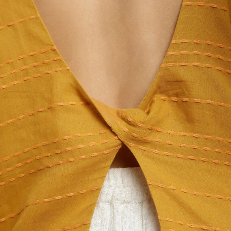 Back Detail of a Model wearing Mustard Cotton U-Neck Straight Top