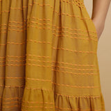 Close View of a Model wearing Mustard V-Neck Handwoven Tier Dress