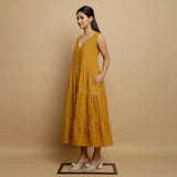 Left View of a Model wearing Mustard V-Neck Handwoven Tier Dress