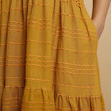 Front Detail of a Model wearing Mustard V-Neck Handwoven Tier Dress