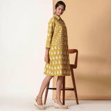 Right View of a Model wearing Mustard Paisley Bagru Block Printed Shirt Dress