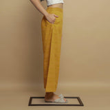 Right View of a Model wearing Mustard Paneled Striped Handwoven Pant